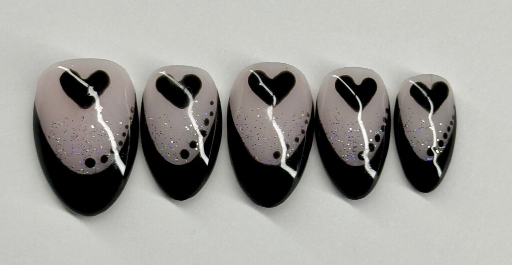 Set of five nail art designs with black hearts on a gray background