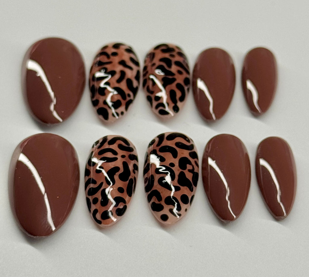 Set of nail designs with brown and leopard print patterns on a light gray background