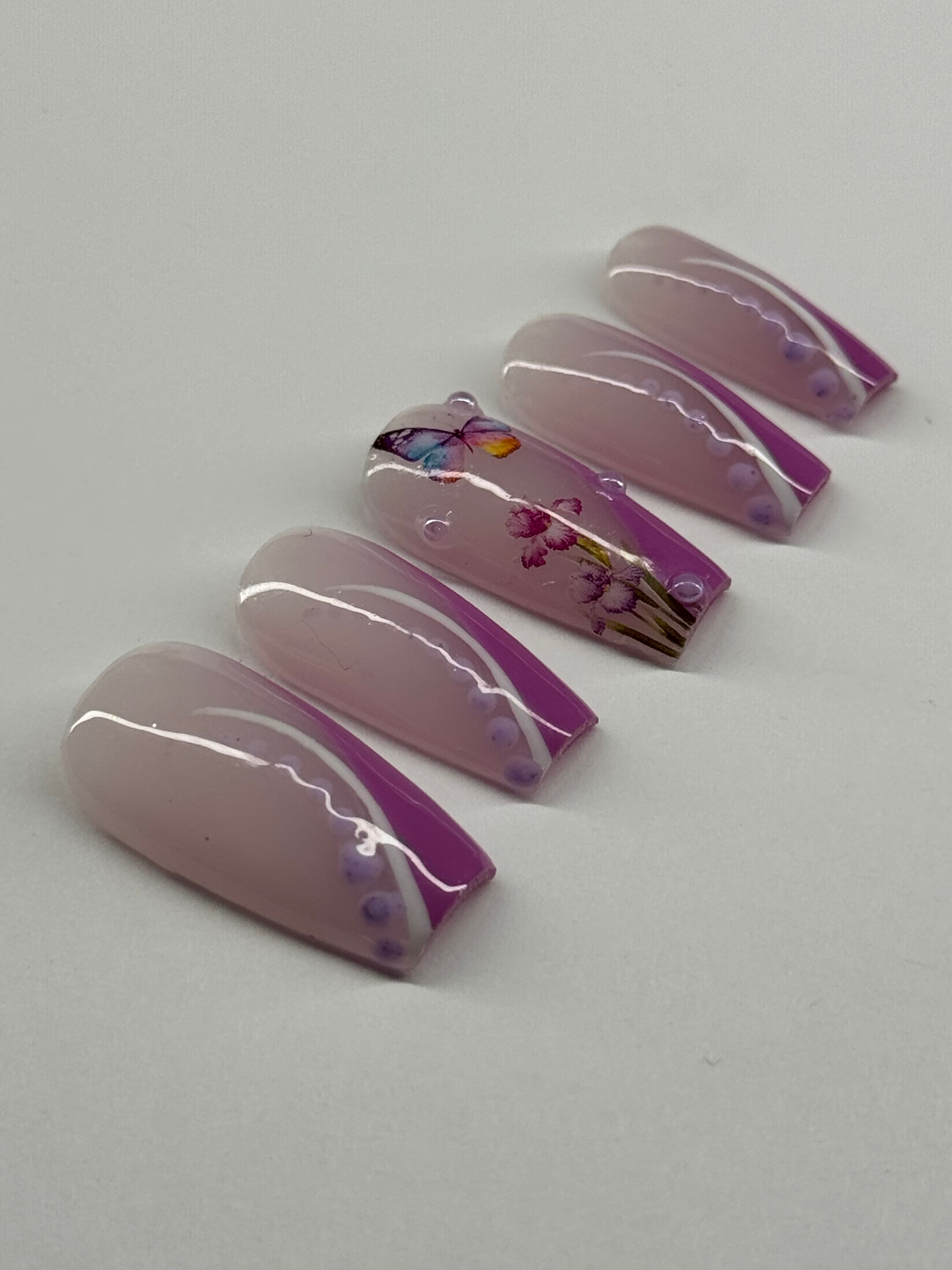 Set of purple and clear nail art designs on a white background