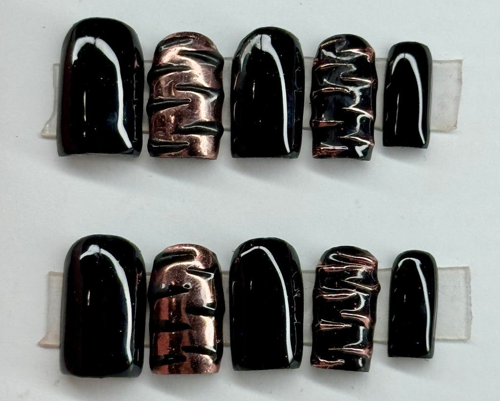 Set of black and copper nail art designs on a white background