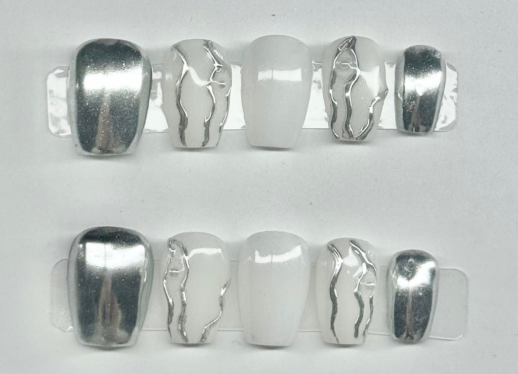 Set of silver hair clips with unique designs on a white background