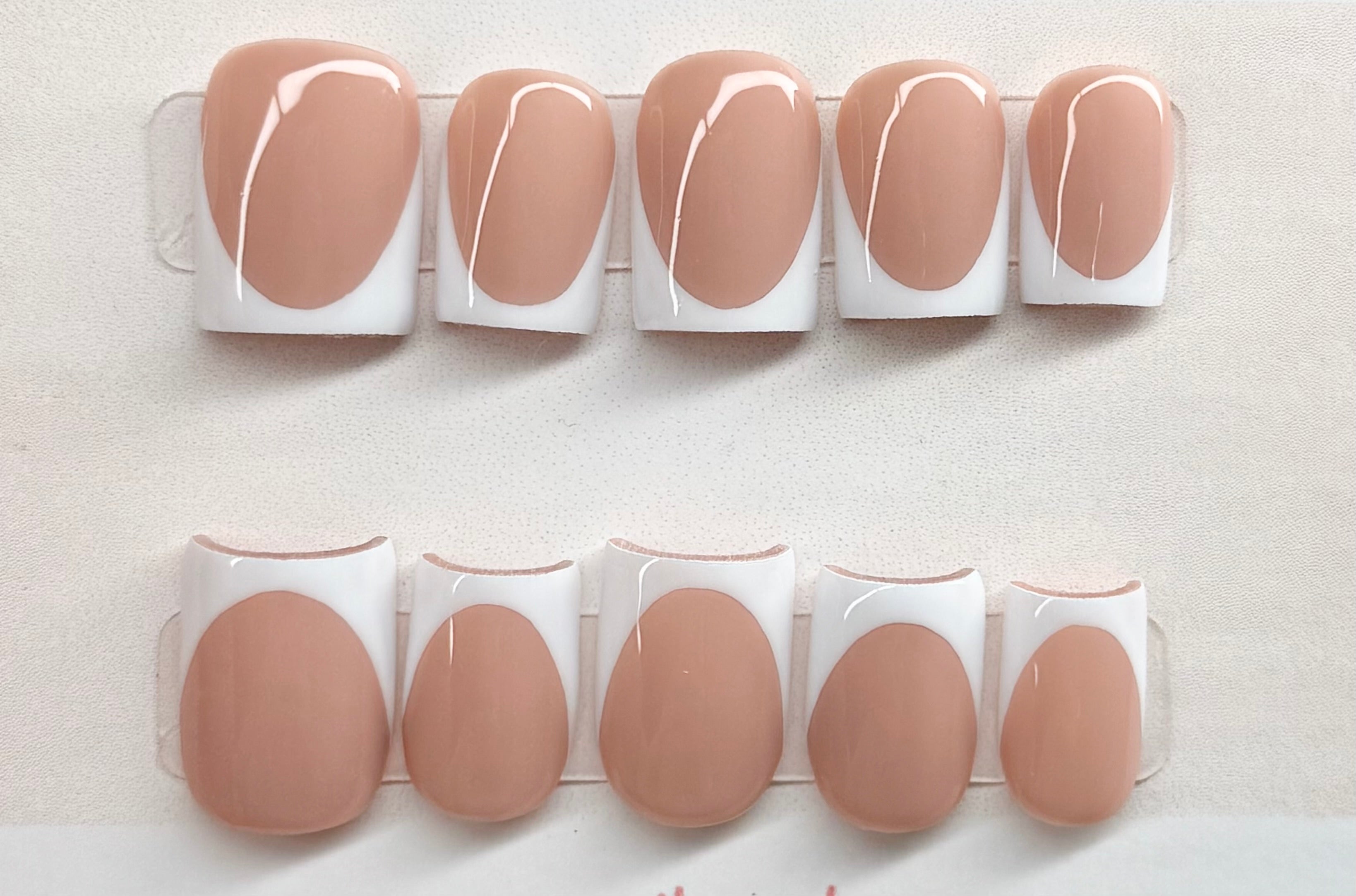 Set of nude base with white french tip nail extensions