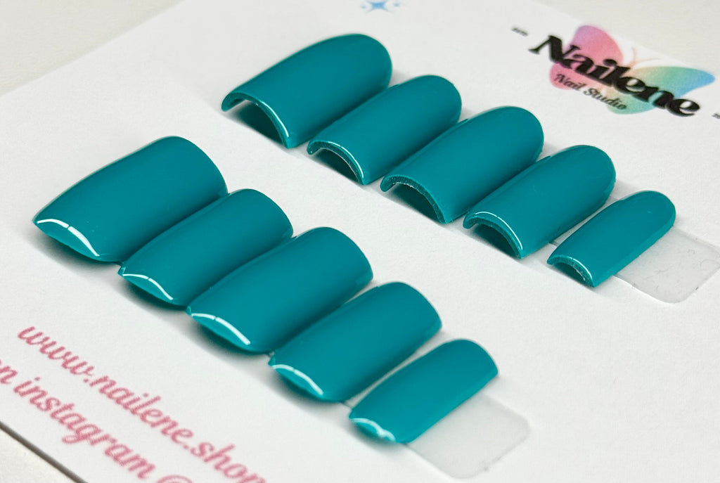Teal nail extensions on a clear sheet with 'Nailene' branding.