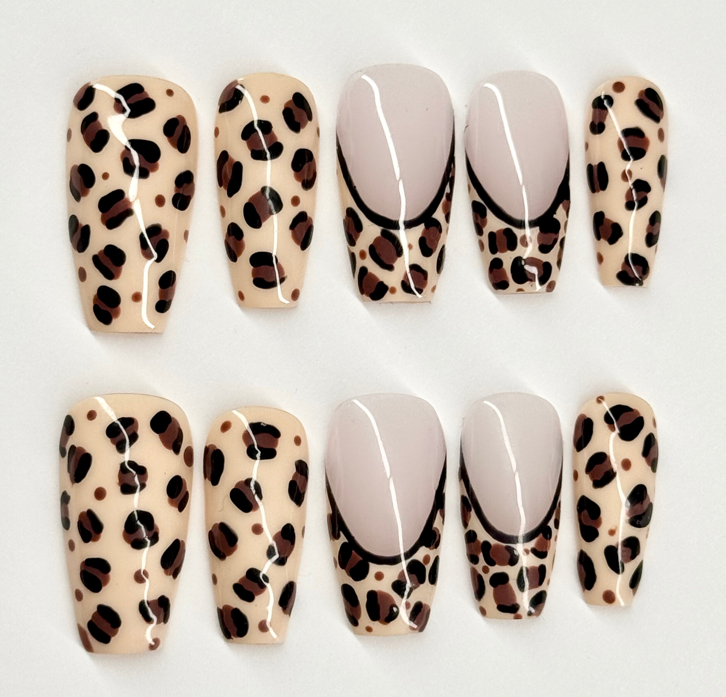 Set of leopard print and plain press-on nails on a white background