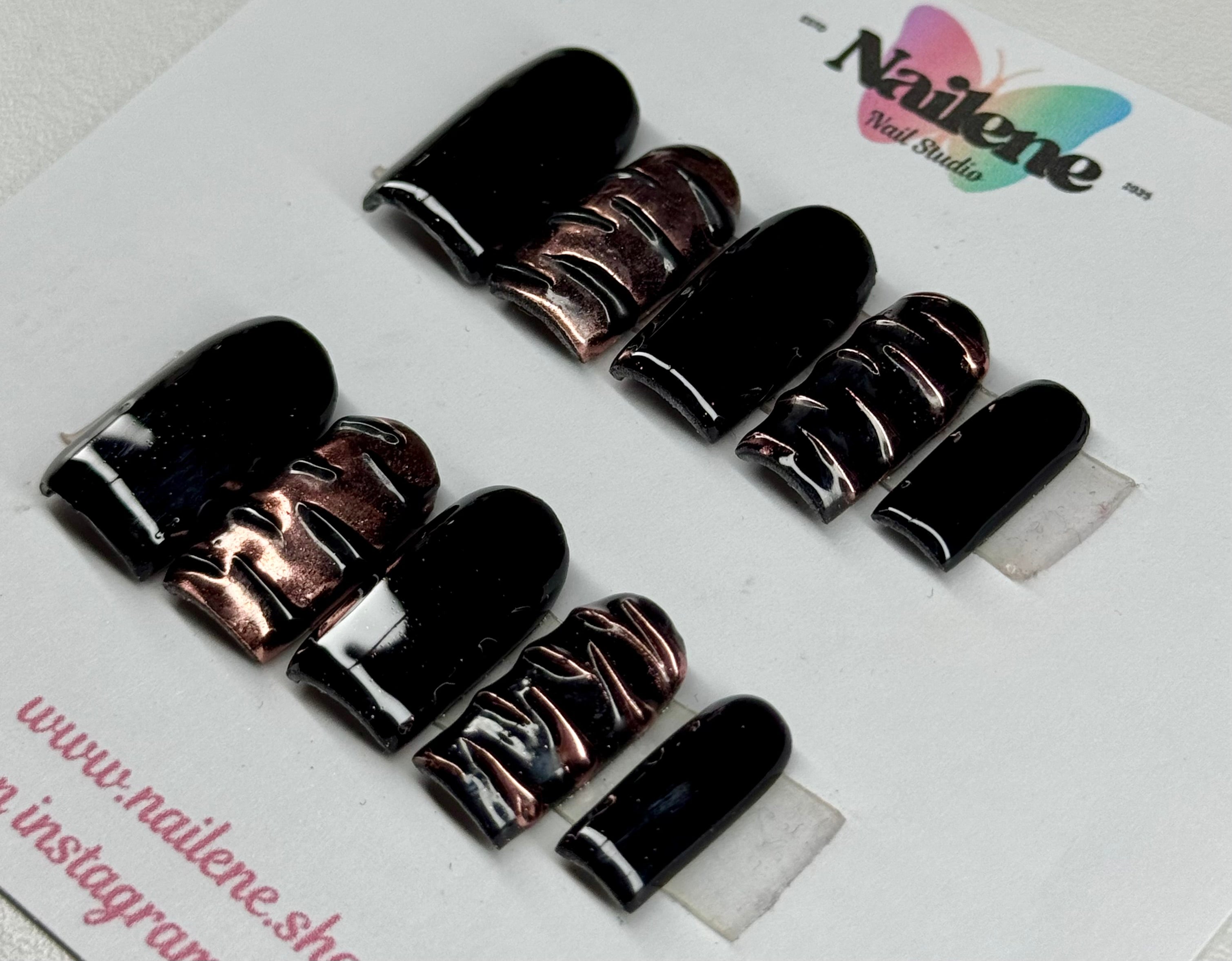 Set of black and rose gold nail polish samples on a white background with 'Nailene' branding.