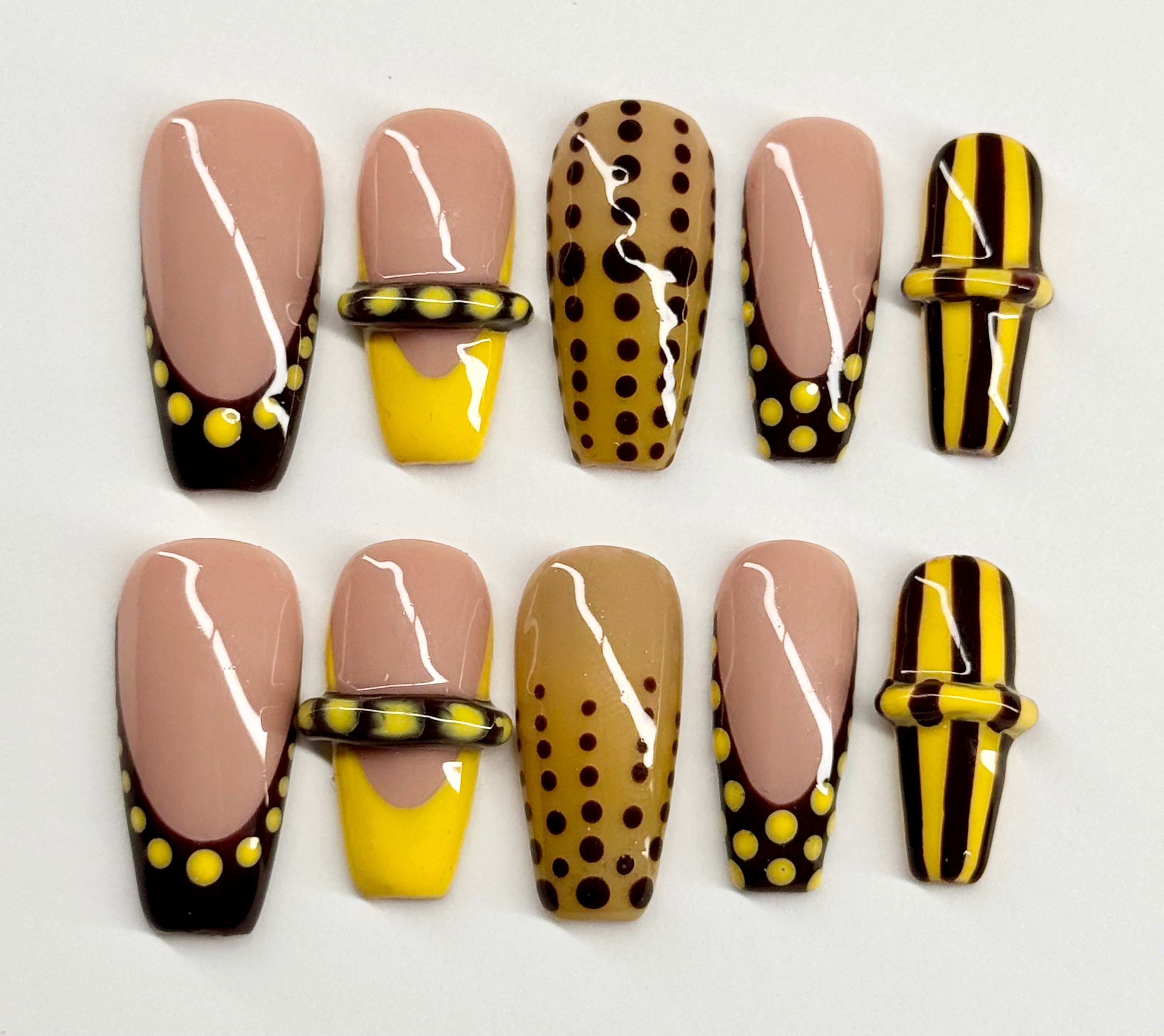 Set of nail designs with polka dots and stripes on a white background