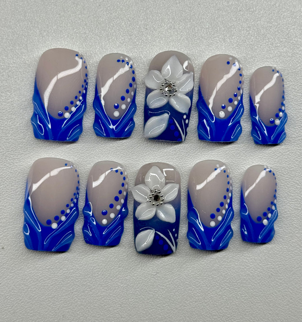 Set of nail art designs with blue, and white colors on a gray background