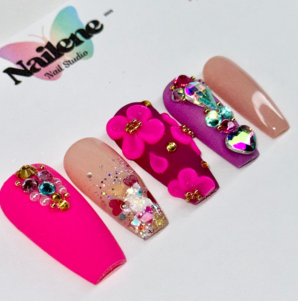 Decorative false nails with flowers and gemstones on a white background, featuring the Nailene Nail Studio logo.
