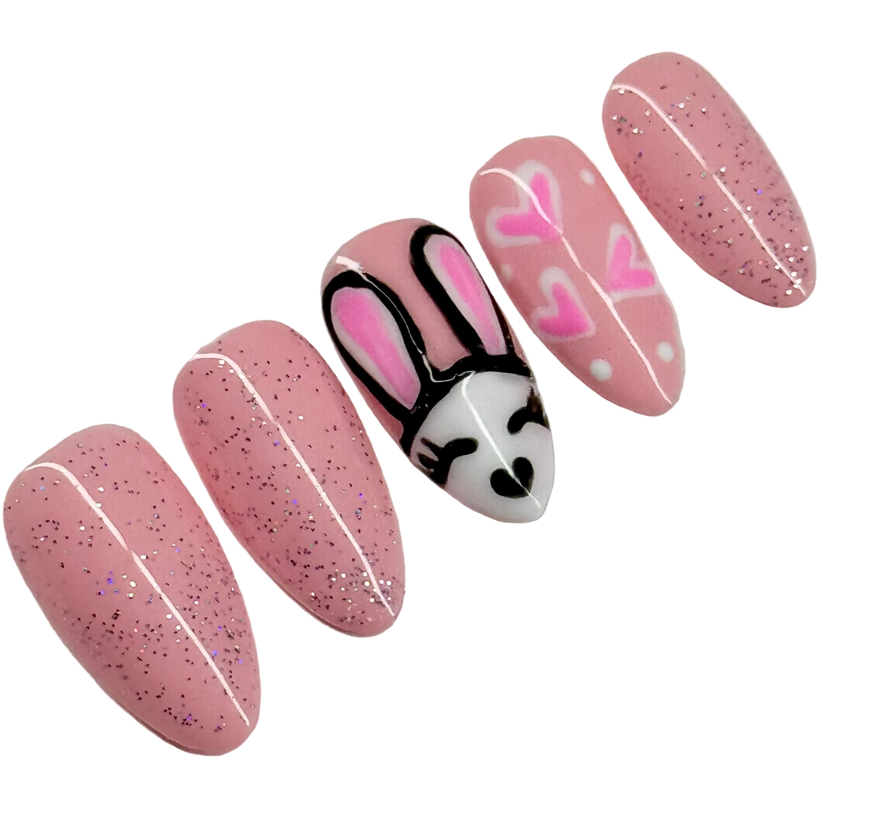 Set of pink glittery nail art with a bunny design on a white background