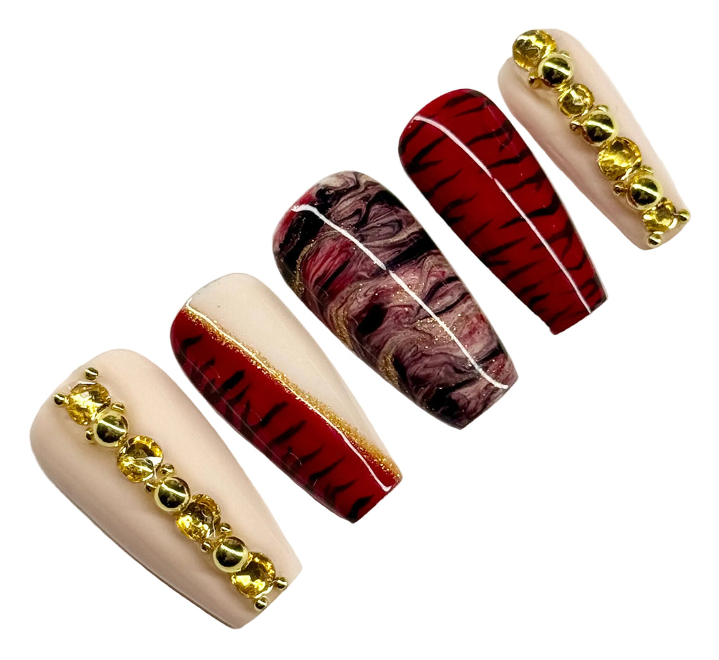 Set of nail art designs with gold accents on a white background