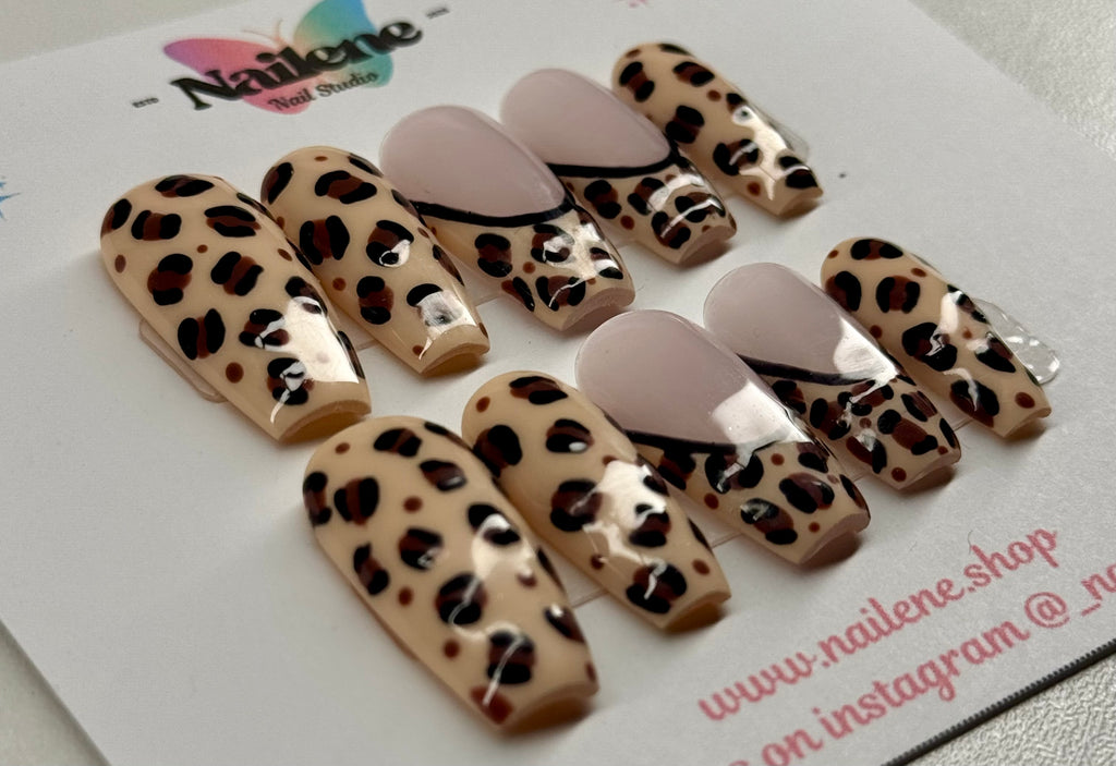 Leopard print nail art designs on beige nails with a visible brand logo in the background.