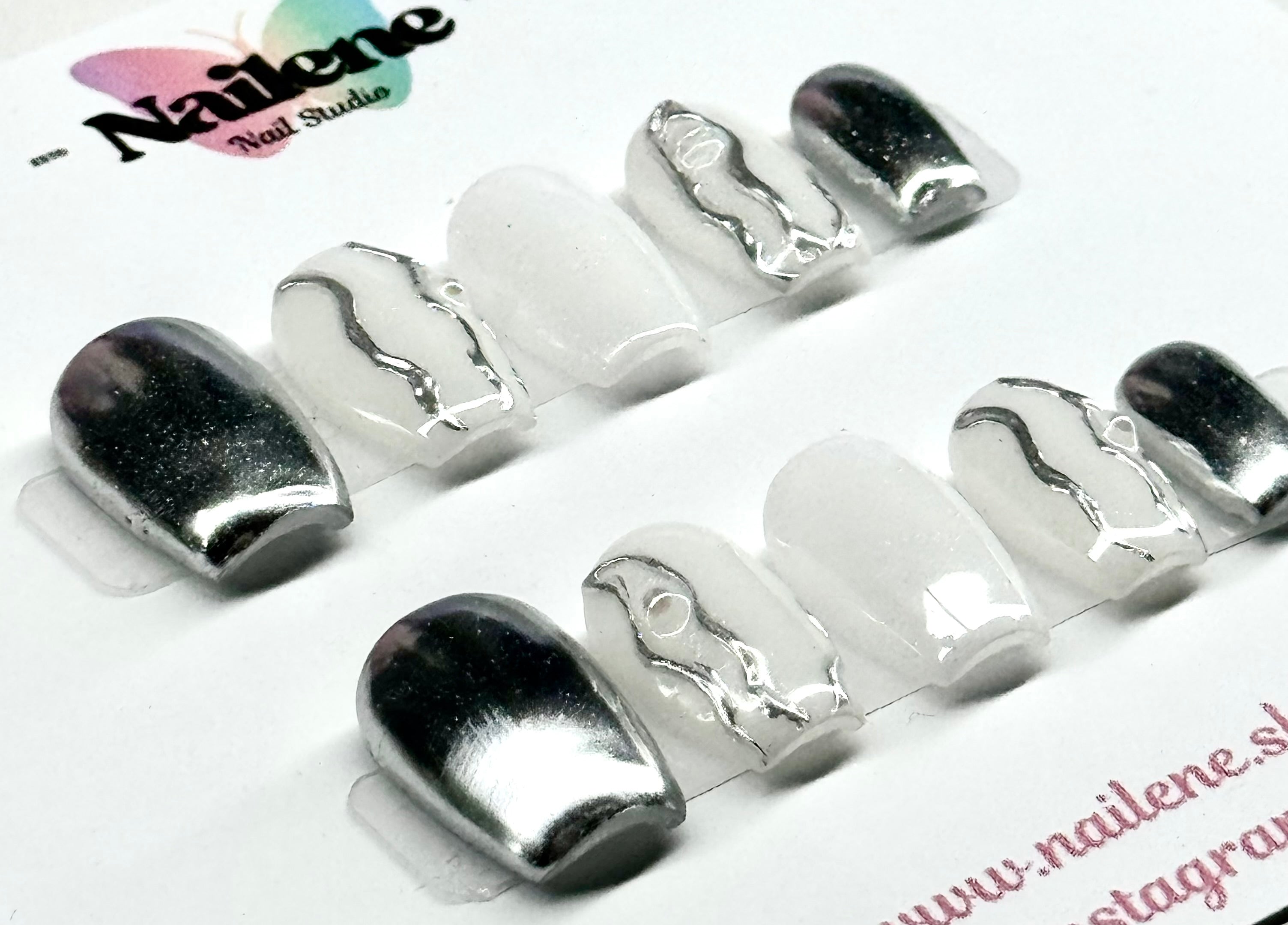 Silver and white nail art designs on a white background with 'Nailene' branding.