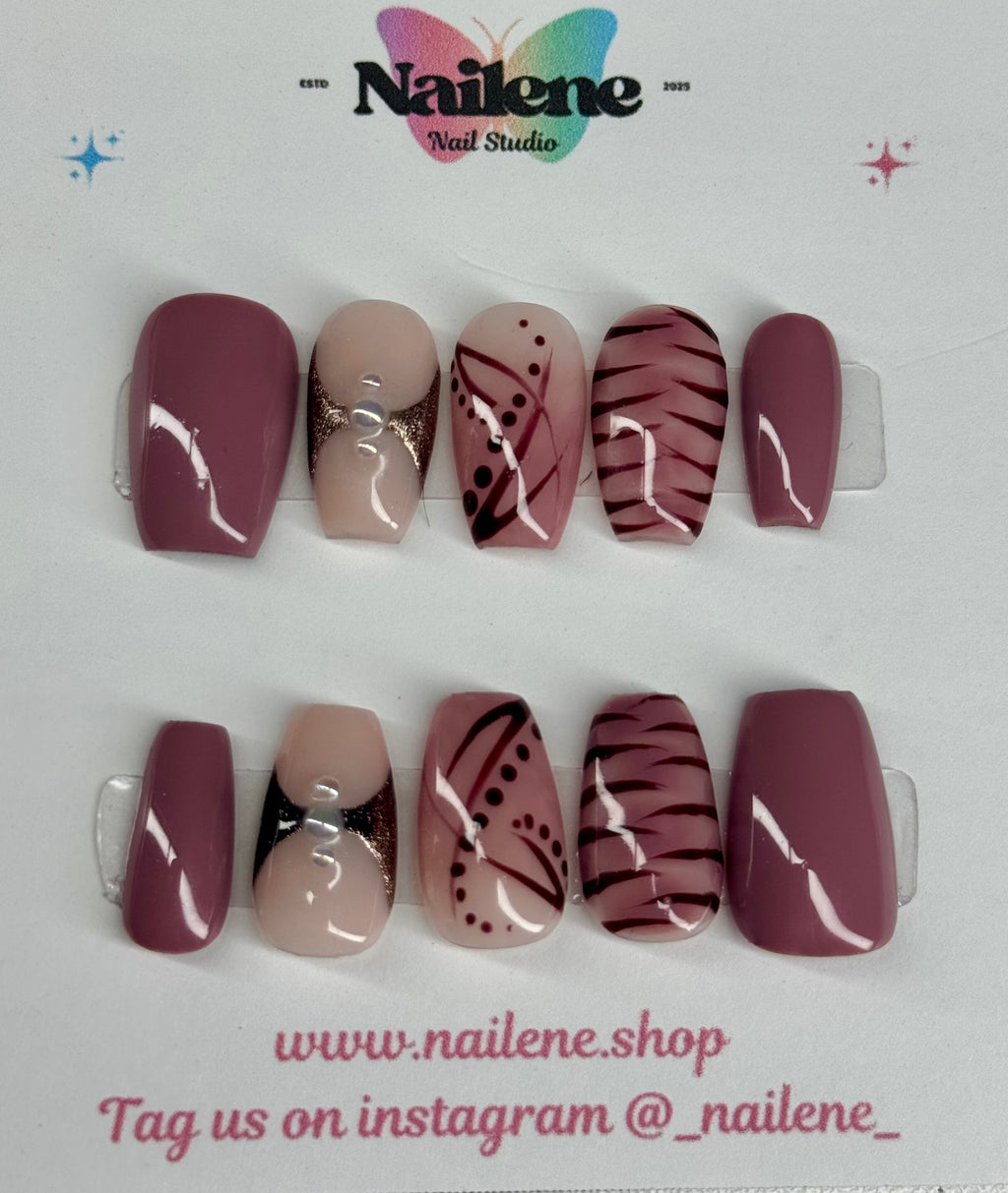 Set of nail art designs on clear display with Nailene logo and website.