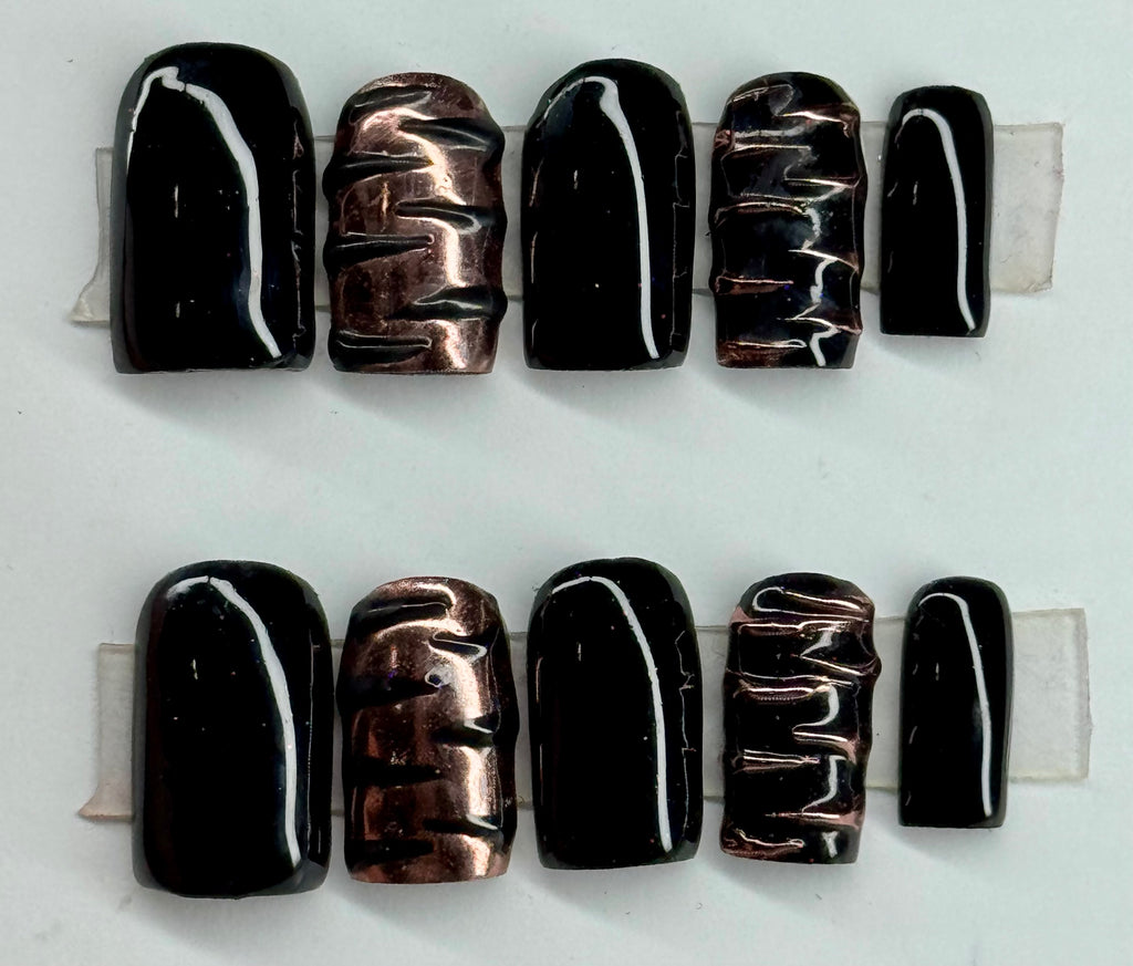 Set of black and copper beads on a white background