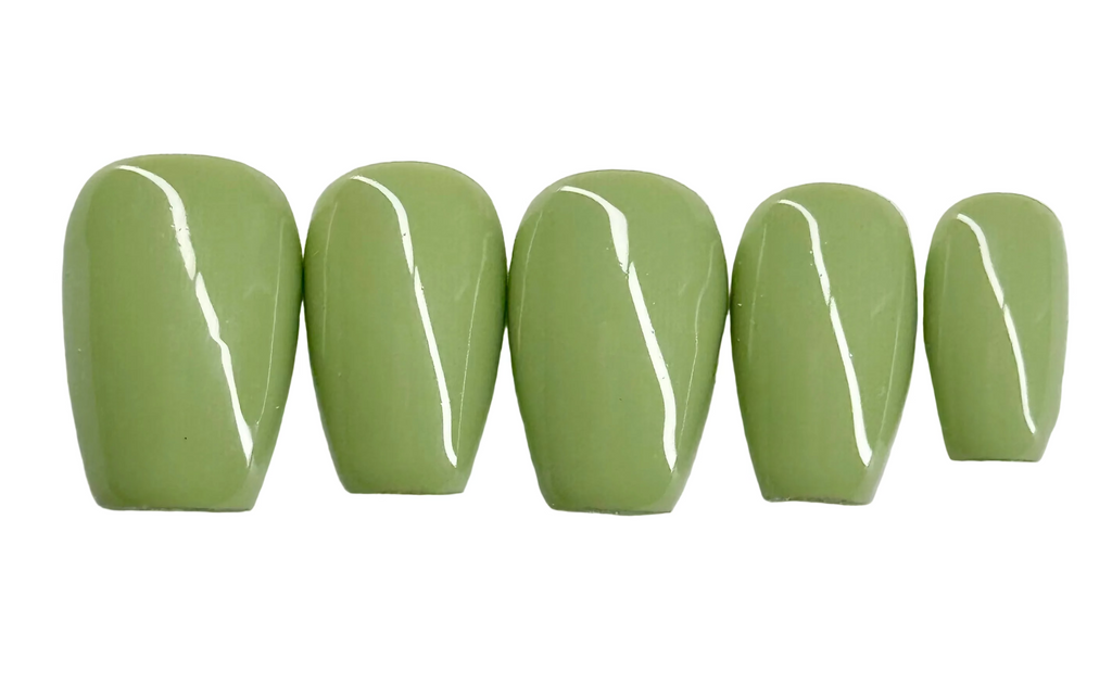 Five green nail polish samples on a white background