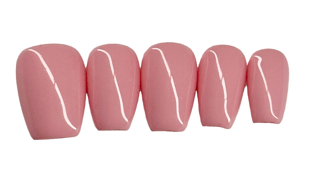 Five pink artificial nails with white lines on a light gray background
