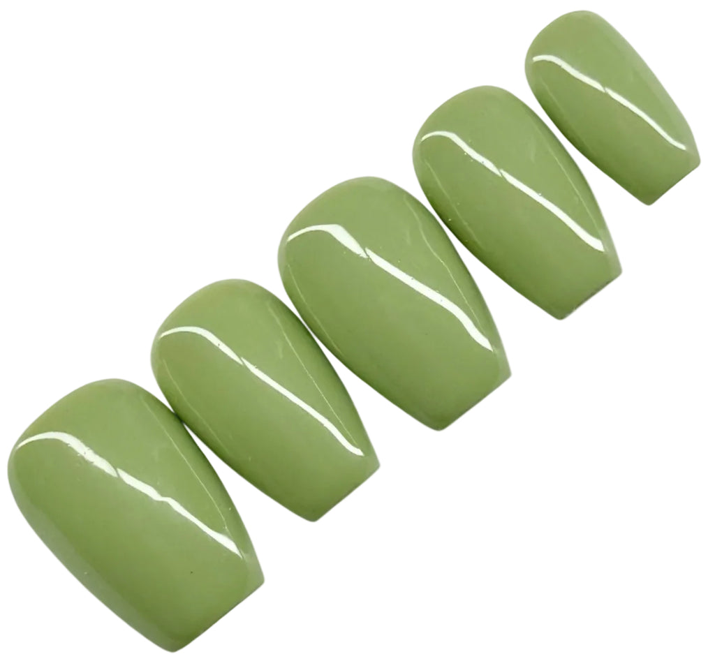 Set of green nail polish on a white background